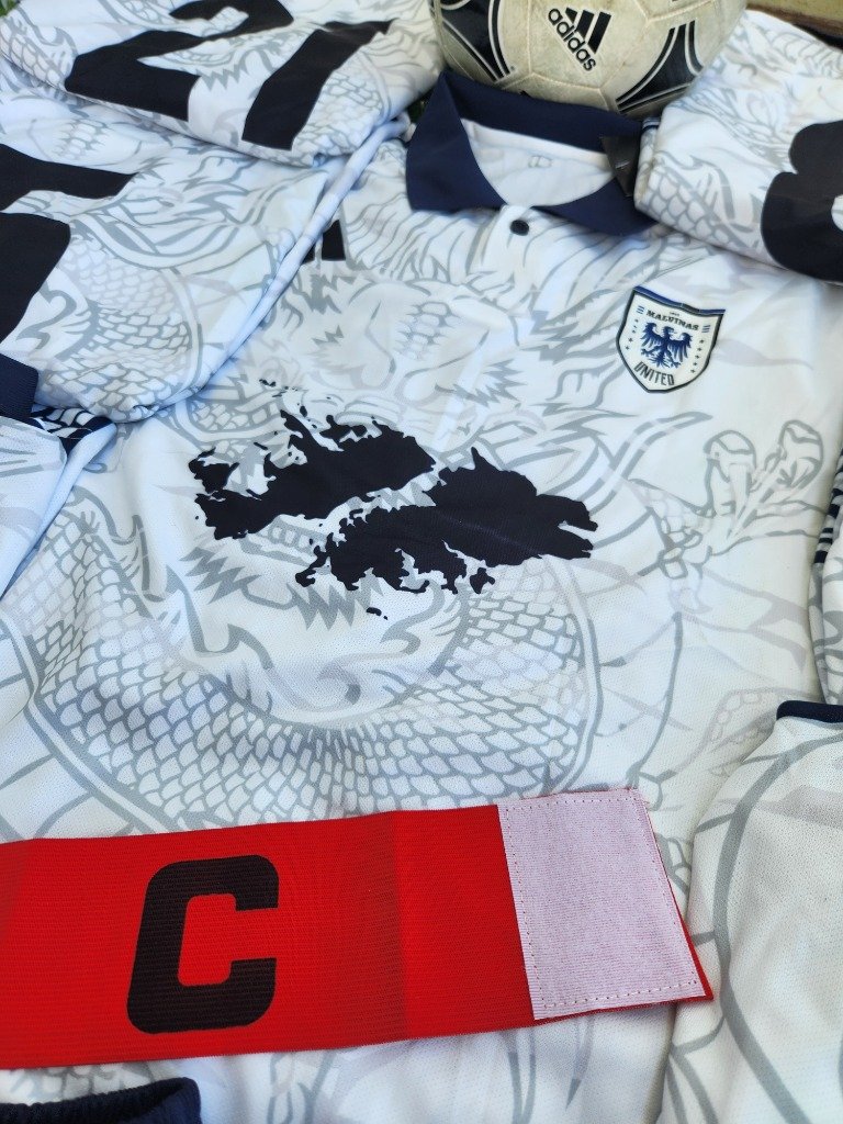 Close-up custom jersey with crest and captain armband